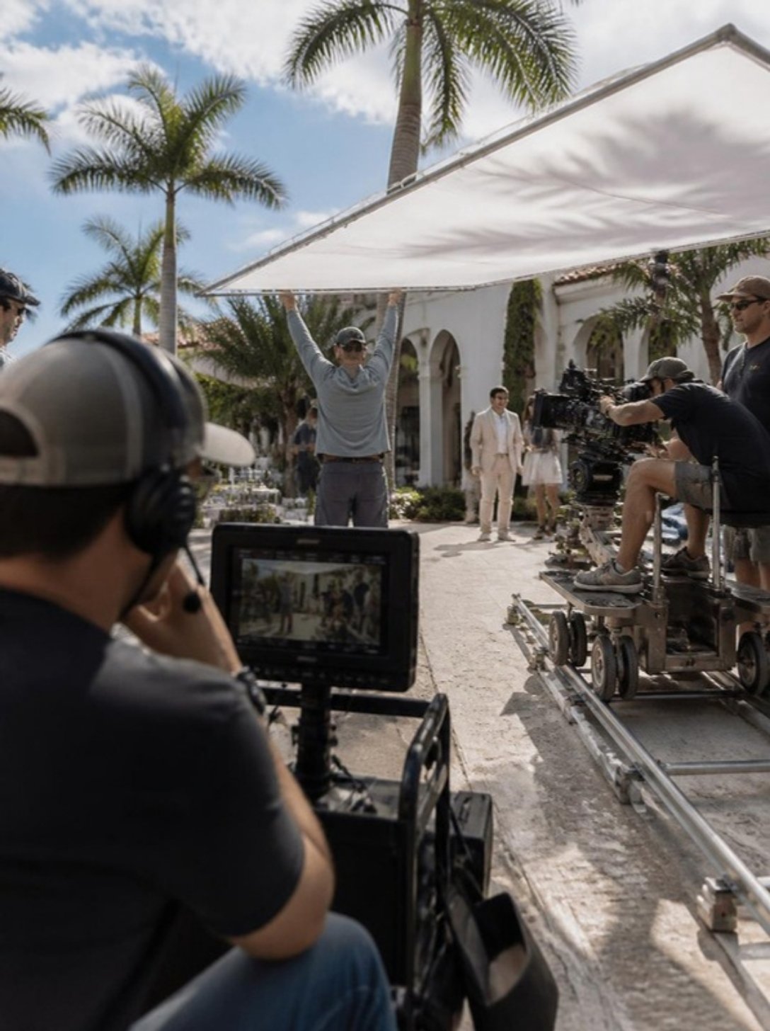 Commercial film crew shooting a campaign on location in Florida with a dolly camera