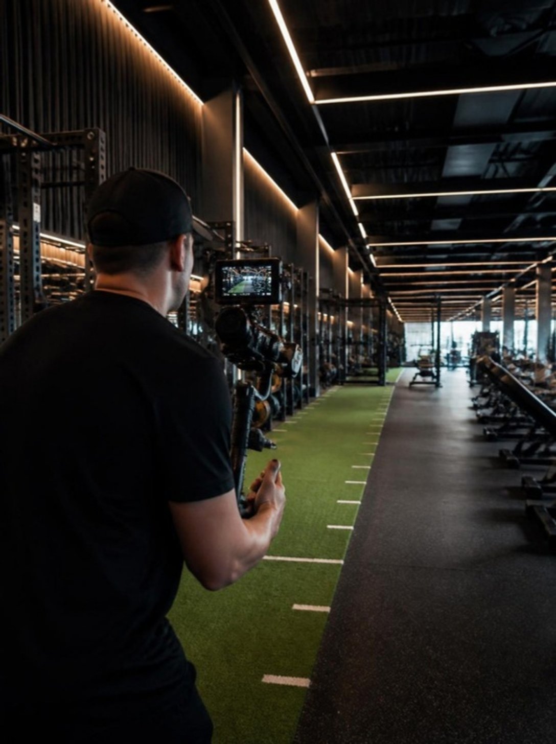 Videographer filming a gym facility tour with a gimbal camera