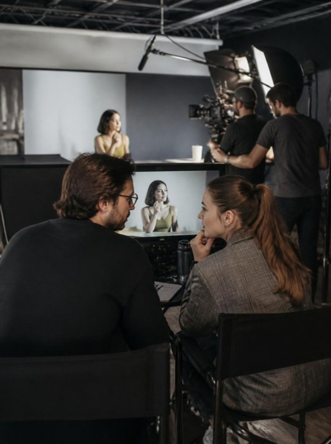 Agency creative team reviewing footage on set while an Orlando video crew films