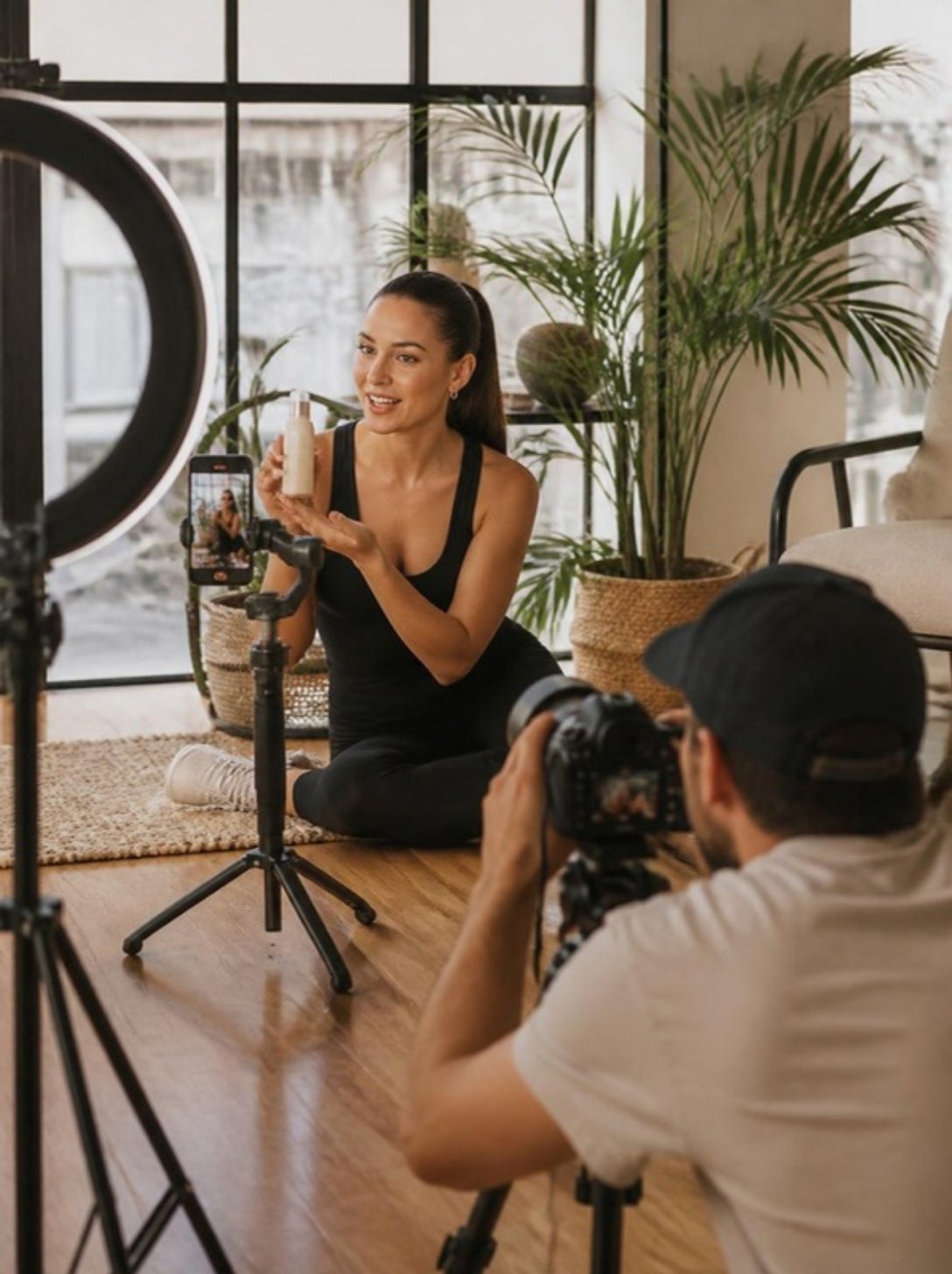 Videographer filming a creator presenting a product during a social media content day